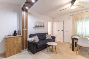 a living room with a couch and a table at El Castañar de Ceubia in Arenas de San Pedro +18 photos