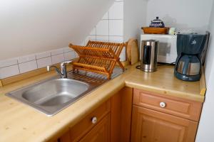 a kitchen counter with a sink and a coffee maker at Mühlenhof in Olbersdorf