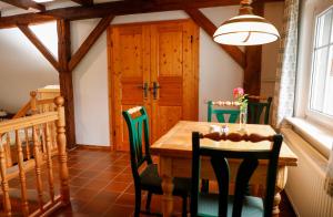 a dining room with a wooden table and chairs at Mühlenhof in Olbersdorf +31 photos