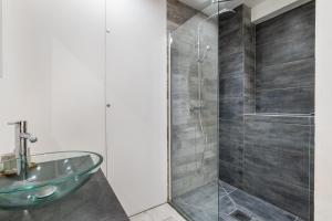 a bathroom with a glass sink and a shower at T2 Cyril Besset in Cagnes-sur-Mer