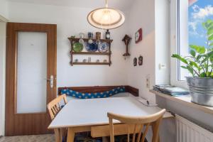 a dining room with a table and chairs and a window at Haus Schild in Grassau +7 photos