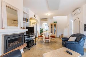 a living room with a fireplace and a table at Las Ramblas in Orihuela