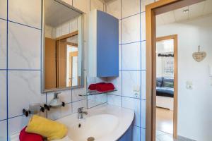 a bathroom with a sink and a mirror at am Hirnach in Sindelfingen +12 photos