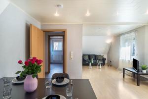 a living room with a vase of flowers on a table at am Hirnach in Sindelfingen