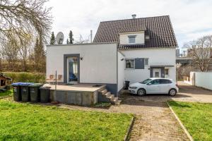 a white house with a car parked in front of it at am Hirnach in Sindelfingen