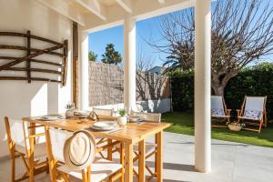 a wooden table and chairs on a patio at Marce in Ciutadella