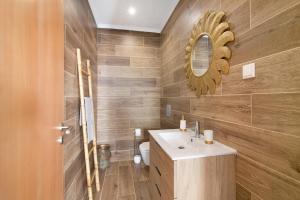 a bathroom with a sink and a mirror at Traditional 3 bedroom apartment in Alte +20 photos