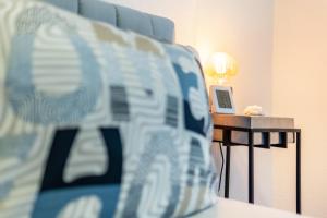 a room with a bed with a table with a laptop at Cozy Corner - Passau in Passau