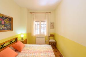 a bedroom with a bed and a window at Cal Vimon in Las Masucas +27 photos