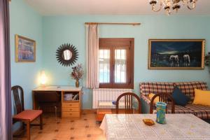 a living room with a table and a couch at Cal Vimon in Las Masucas
