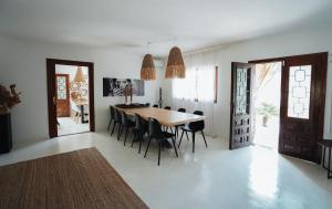 a dining room with a wooden table and chairs at Villa Carol in Illes Balears