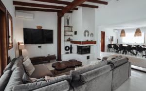 a living room with a couch and a tv on the wall at Villa Carol in Illes Balears