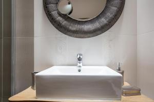 a bathroom with a sink and a mirror on the wall at Casa Rural La Morisca in Tuineje +14 photos
