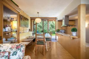 a kitchen and dining room with a table and chairs at Haus der Sinne Bregenzerwald in Tannen