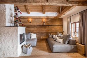 a living room with a couch and a tv at Obereggeralm in Valdaora
