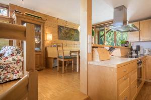a kitchen and dining area of a tiny house at Haus der Sinne Bregenzerwald in Tannen +19 photos