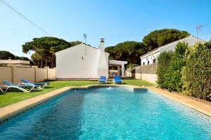 a swimming pool with two chairs and a house at Villa Perez Zara 3 in Campano