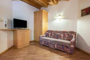 a living room with a couch and a flat screen tv at Lindenhof Apt 4 in Vandoies