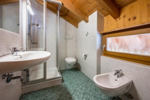 a bathroom with a sink and a shower and a toilet at Lindenhof Apt 4 in Vandoies +11 photos