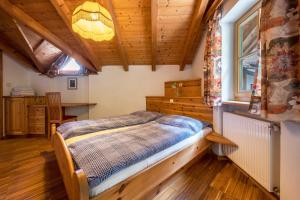 a bedroom with a bed in a room with wooden ceilings at Lindenhof Apt 4 in Vandoies