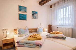 two twin beds in a bedroom with white walls at Ferienwohnung Nr 3 in Deggenhausertal