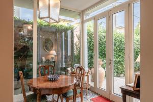 a dining room with a table and chairs and glass doors at Villa Manuela Flat in Chiesina Uzzanese