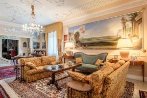 a living room with couches and a painting on the wall at Villa Manuela Flat in Chiesina Uzzanese