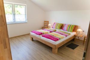 a couch with colorful pillows sitting in a room at Bauernhof Mayer in Owingen