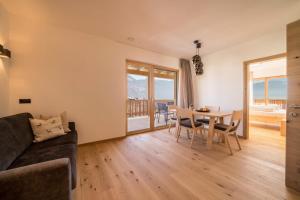 a living room with a couch and a table at Apt Lärche - Nockerhof in Andrian +15 photos