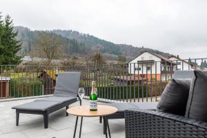 a patio with two chairs and a bottle of champagne at Sonne und Mehr in Stockach
