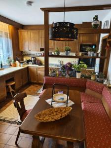 a kitchen with a wooden table and a couch at Ferienhaus Wurzinger in Mureck