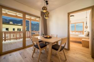 a dining room with a wooden table and chairs at Apt Lärche - Nockerhof in Andrian