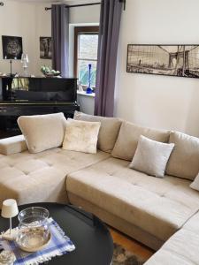 a living room with a couch and a piano at Ferienhaus Wurzinger in Mureck