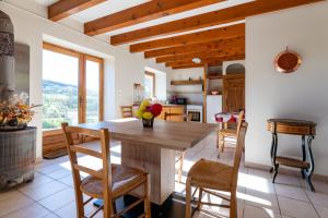 a kitchen with a wooden table and chairs at Le Mas Saint Victor in Saint-Victor +12 photos