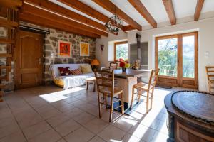 a kitchen and living room with a table and chairs at Le Mas Saint Victor in Saint-Victor
