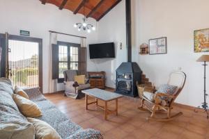 a living room with a couch and a wood stove at Finca Liarte in Murcia