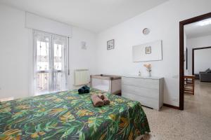 a bedroom with a bed with a teddy bear laying on it at A due passi dalle terme e dal lago in Trescore Balneario