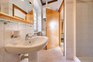 a bathroom with a sink and a mirror at Rustico alle Fornare in Torri del Benaco +20 photos