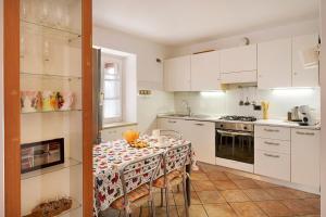 a kitchen with a table with a table cloth on it at Rustico alle Fornare in Torri del Benaco