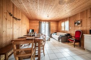 a living room with a table and a couch at Sherpa - 10 pers in Saint-Jean-d'Aulps