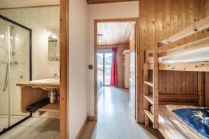 a room with bunk beds and a bathroom with a sink at Sherpa - 10 pers in Saint-Jean-d'Aulps