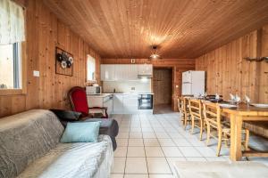 a living room with a couch and a table and a kitchen at Sherpa - 10 pers in Saint-Jean-d'Aulps +15 photos