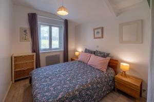 a bedroom with a bed and a window at Domaine de Lestroué - Belle-île in La Vraie-Croix