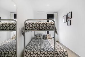 a bedroom with two bunk beds in a room at Apartamento Punta Candor in Rota +29 photos