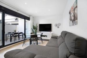 a living room with a large couch and a table at Apartamento Punta Candor in Rota