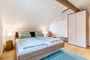 a bedroom with a bed and a white cabinet at Ferienwohnung Kist in Sasbachwalden +43 photos