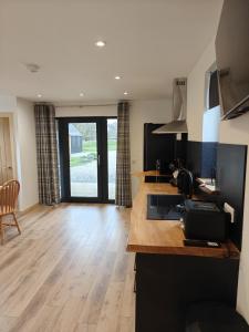 a kitchen with a wooden counter top in a room at Temuka Lodge in Glenurguhart