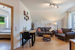 a living room with a couch and a table at Ferienhaus Am Brande in Schmallenberg