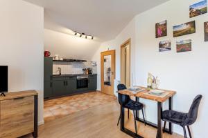 a kitchen and living room with a table and chairs at Ferienhaus Am Brande in Schmallenberg