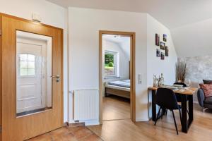 a room with a table and a door leading to a bedroom at Ferienhaus Am Brande in Schmallenberg +10 photos